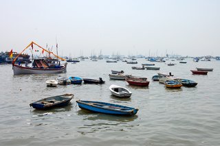 Touring India - Photo 17 of 27 - In Mumbai's harbor, boats speckle the water. They looked to be so close to one another that I imagined being able to jump from one to the next like lilly pads.
