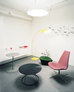 Swedish Designer Focus: Monica Förster - Photo 5 of 9 - The studio’s front room is a makeshift showroom, open to the public three days a week. Among the wares on view are Förster’s yellow Cirle lamp, made of bent sheet metal with a matte rubber finish; a mauve Spoon chair, inspired by the shape of Japanese spoons; the Umbrella pendant lamp; Mix bowls and vases, made of crystal and plastic; and three low pieces (from left to right), the Cake table, the Breeze coffee table, and the asymmetrical Drop stool.