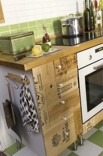 "I’m not usually a big fan of ‘visible’ recycling," notes Scholtus, "but I love the way the recycled wine boxes look and feel in contrast to the bright and shiny grass-green-and-white tiles."