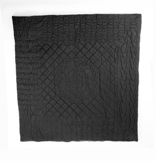 Wong's works grappled with perceptions of safety and security in post-9/11 America. This quilt is made from ballistic nylon, a material typically used in military applications as a protective shield from flying debris. Here, Wong uses the material in a quilt (a comforting object) with a rather traditional pattern, commenting on a need for a different sense of comfort and security.<br><br>Tobias Wong, <br><br>Bulletproof Quilted Duvet, 2004, ballistic nylon, cotton, and cotton flannel; Collection SFMOMA, gift of Josee Lepage; © Estate of Tobias Wong; photo: courtesy SFMOMA.