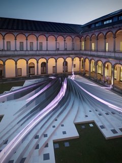 A nighttime view, all lit up with Artemide fluorescent tubes.