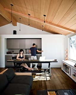 After meals are made, the sliding doors hide the anodized aluminum Miele fixtures, creating a clean, uncluttered look.