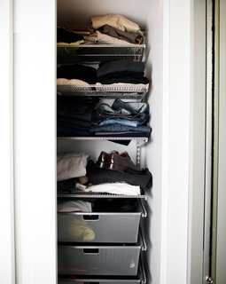 Elfa storage systems fit perfectly behind the sliding doors, and offered customizable options for keeping clothes organized.