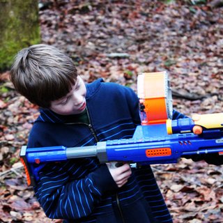 Henry takes aim with his Nerf gun while visiting the property. The forested site has provided a perfect backdrop for epic Nerf wars and other makeshift battles. The kids have gotten to know the site and become comfortable in their future backyard during frequent trips over the last couple years.