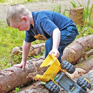 Charlie, our youngest sets up his own construction site on the property and transfers some wood chips with the help of his truck. He's practically grown up on the property and the transition to his future playground has been seamless.