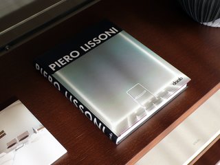 A book of Lissoni’s designs from daab rests on a shelf in his System NXT.