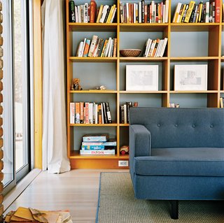 Long Island Found - Photo 11 of 12 - In the living room, a warm woodsy palette reigns, with a few blue-gray notes to create a serene mood.