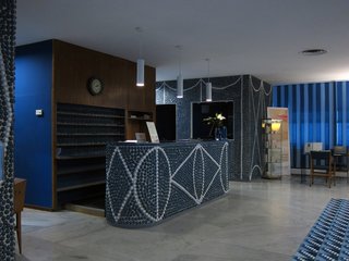 The lobby gives visitors an immediate sense of the hotel's design vocabulary. With the exception of some wood accents, almost every surface is either blue or white. Thousands of ceramic "pebbles" are set into the walls, adding an almost unbelievable level of workmanship and craft to the interior.