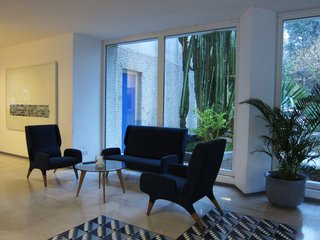 The lobby's waiting area includes a few vignettes of Ponti's original furnishings, which are clad in their original upholstery (though restored in a recent renovation). This set-up includes the 899 armchair and sofa.