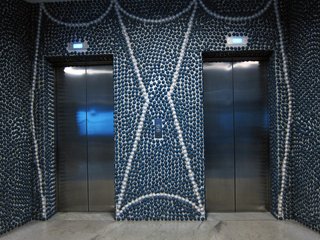 Although the elevators' interiors were one of the few things to be upgraded in a recent renovation, Ponti's elaborate graphic designs for the ceramic pebble surfaces remain intact.