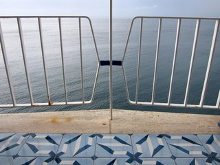 A view of the sea through the wrought iron balustrade on our room's balcony.