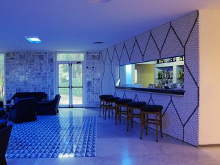 The bar itself is faced with more ceramic pebbles with the lobby's color scheme in reverse. One can only imagine how swinging it must have been in 1962.