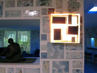Throughout the first floor lounge and lobby areas, clever lamps made from folded metal are set atop Melotti's tiles.