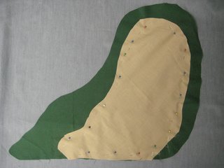Lay the tan fabric on top of the green, and cut out a piece that will be Jabba's face and belly. It doesn't have to be perfect! You can freehand this part, or draw your shape with chalk and then cut it out. Pin this to one layer of the green fabric.