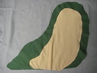 Sew the tan fabric onto one of the green pieces. I tucked a teensy bit under for a little hem and used a sewing machine, but you could just as easily hand stitch this part.
