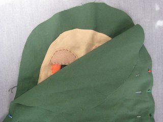 Pin the right sides of the two green pieces together (Jabba's face will be on the inside). Once they're secure, sew around the outside edge, leaving a few inches open and un-stitched. When you've finished, turn Jabba inside out. At this point he's a pillowcase.