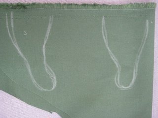 I have to admit, arms were an afterthought for me. Were I doing this again, I'd cut them out, stuff them, then stick them in before step 12, so they'd be part of the seam. It still worked this way, though. Double up the green fabric, then draw, and cut out, two little arms.