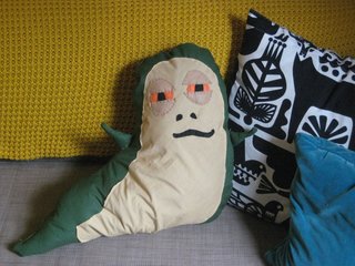 And here's Jabba, just chilling with his new pillow pals in his new home, my sofa. I have to admit, just looking at him makes me laugh, and he's actually a comfy addition to the living room scene.