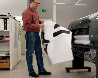 Juslin inspects a printout for a new printing screen.
