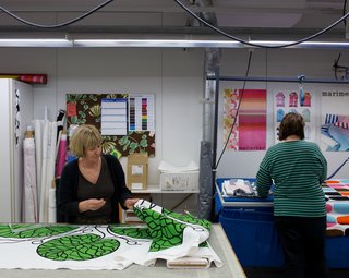 Workers in the on-site sewing area prepare textiles to become linens, bags, and more.