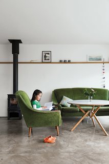 A late-1950s set of sofa and chairs inherited from Gaffney’s granny warm up the living room, as do the stove from Charnwood and the coffee table the couple bought from Habitat for their first flat.