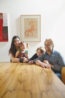 Wilkin and Pini, together with their children Ava and Tom, sit at a dining table made from black heart sassafras, an Australian wood.