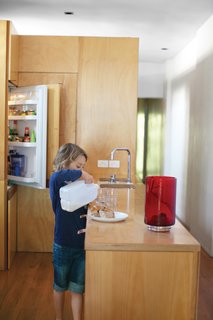 The kitchen is built from hoop pine plywood, including the countertops and front of the refrigerator. The leather drawer-pulls will patina over time.