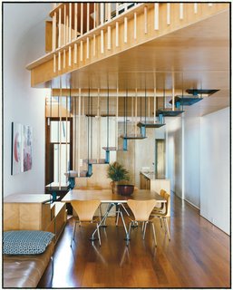 The addition’s most eye-catching feature is the steel staircase with recycled blackbutt wood treads. The bottom steps double as benches to supplement the six Arne Jacobsen Series 7 dining chairs for Fritz Hansen and a Nomos table base by Sir Norman Foster for Tecno.