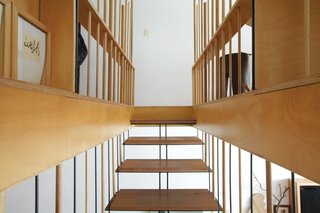 Inspired by tansu chests and raw materials that show patina, a pair of Sydney-based architects renovated their own home—slowly. The steel-and-wood stairs lead to the master bedroom and study.