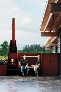 Metals broker S. J. Sherbanuk (left) and designer James Campbell (right) created a new home in Collingwood, Ontario, with old scrap. "Repurpose, refurbish, recycle" was the guiding principle for the project. The modern, metal fireplace becomes a sculptural feature of an outdoor deck.