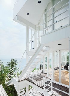 This Lake House Is a Living Piece of Architecture History - Photo 3 of 21 - The Douglas House is a clear nod to Les Terrasses, a 1928 residence created by Le Corbusier in Garches, France. Shared elements include curved walls, spatial ambiguities, and the series of ladders and cantilevered staircases that join the levels and encourage a cascading architectural promenade.