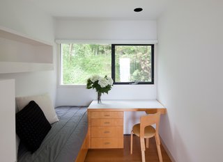 This Lake House Is a Living Piece of Architecture History - Photo 17 of 21 - A desk in the guest bedroom fits tidily next to the bed.