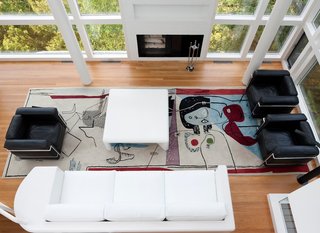 This Lake House Is a Living Piece of Architecture History - Photo 19 of 21 - The view overlooking the living room, which features the famous Le Corbusier rug by Edward Fields. The residents were also careful to save the sofa, which Meier himself designed for the space.