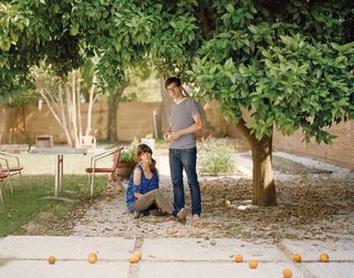 Helen and Josh in their back yard, next to the concrete pavers they poured themselves.