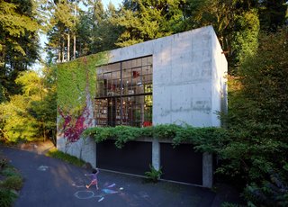 50 Modern Homes With Floor-to-Ceiling Windows - Photo 48 of 50 - The Brain is a 14,280 cubic-foot cinematic laboratory where the client, a filmmaker, can work out ideas. Physically, a garage—that neighborhood birthplace of invention—provides the conceptual model. The form is essentially a cast-in-place concrete box, intended to be a strong yet neutral background that provides complete flexibility to adapt the space at will. Inserted into the box along the north wall is a steel mezzanine. All interior structures are made using raw hot-rolled steel sheets. Photo by Marco Prozzo.