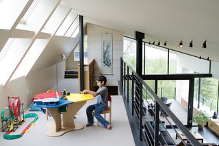 The loft above the living room is Suresh's terrain, given over to toys, books, and a colorful Lego table. The Clerestory windows maximize the natural light in the house—essential since there are only three hours of sun on a typical winter day.