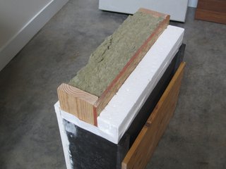 Our R-38 wall section. Rockwool insulation is placed in the 2x6 cavity, and 3.5 inches of continuous expanded polystyrene insulation is screwed to the outside of the oriented strand board shear wall. A benefit to this exterior insulation is that the thermally conductive bridge of the wood studs is broken by insulation. Even a thin layer of exterior insulation can make a big difference.