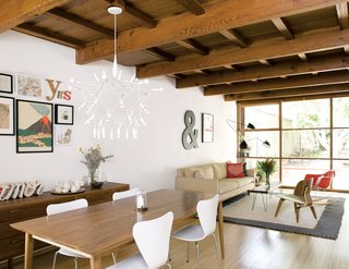 The couch and dining room table are from Room & Board; the Patrick Townsend Orbit Chandelier is from Velocity Art and Design.