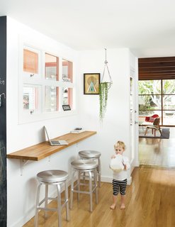 A wall-mounted oak bar is where Siminovich and Kerner drop their keys, pound away on their laptops, and occasionally eat a quick meal with Matilda, their two-year-old daughter.