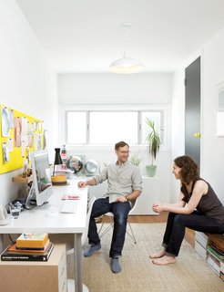 What was once a storage space is now a sun-drenched home office where the couple writes emails and stores their design magazines. The jute rug is from West Elm; the desk is a door on Ikea legs.