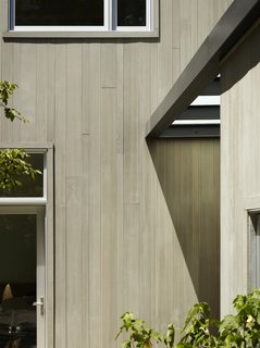 Boards, Battens, and Bevels: Wood Board Siding Types and Their Uses - Photo 5 of 9 - Tongue-and-groove wood siding will often create a smooth surface, because the interlocking edges are hidden. Without the shadow lines from other types of siding, this house employed varying widths of a cedar siding to create a subtle pattern.