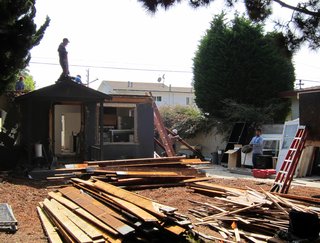 Dwell Home Venice: Part 5 - Photo 3 of 6 - Windows, doors and cabinets are stacked on the driveway. Lumber is sorted into piles according to size and type. The large front yard acts as a staging area.