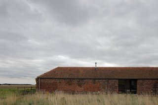 Long and low, the Ochre Barn began its life as a threshing barn in the 1850s.