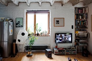 A Little Apartment Gets a Solid Renovation - Photo 8 of 8 - When it comes to media storage in a small space, consider making the most of your nooks and crannies. The shelving at right here is smartly recessed into a cavity next to the window.
