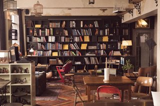 The back wall of the lobby is dedicated to a library and reading area.
