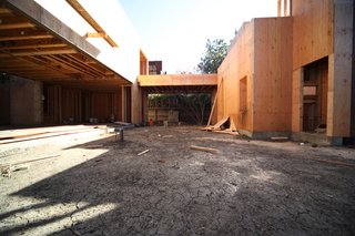 The main courtyard looking south. The bridge in the center of the photo connects the east and west parts of the house and was required by the City in order to meet building code. The need for this connecting bridge was discussed in our blog posts 2 and 3.