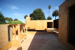 A view east from the rooftop garden above the master bedroom. On the right is the entry to the media studio and from there the bridge to one of the guest bedrooms. The foreground area is reinforced to withstand the strong loads from soil that will be installed in the garden.
