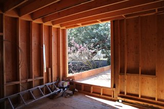 A guest bedroom looks onto the bridge that connects the two parts of the house.