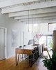 Modern home with Kitchen, Wood Counter, and Pendant Lighting. Nicolas Gervais designed the pendant lights above the kitchen island, which was designed by Plasse and built by woodworker Stéphane Bilodeau. Photo of Examples of Rustic Modern Done Right