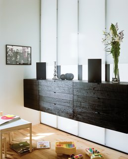 Near the entrance is the front room, or music room, their daughter’s current favorite play area. "Every space needed to be used efficiently," Parisien notes of the home’s remodel.
